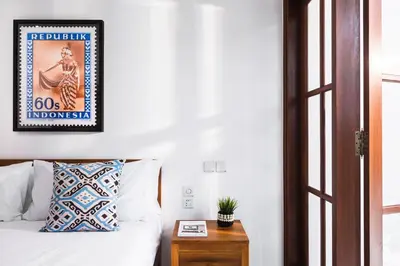 a bedroom with a bed and a picture on the wall at Villa Anahera Seminyak in Seminyak