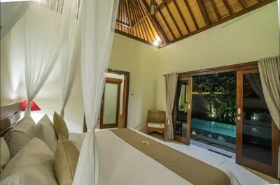 a bedroom with a bed and a window with a train at Villa MD 3 bedroom, Sunny Pool in Eat st location in Seminyak