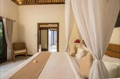 a bedroom with a large white bed with curtains at Villa MD 3 bedroom, Sunny Pool in Eat st location in Seminyak