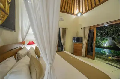 a bedroom with a white bed and a window at Villa MD 3 bedroom, Sunny Pool in Eat st location in Seminyak