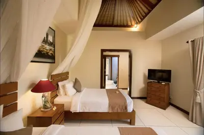 a bedroom with a bed and a television in it at Villa MD 3 bedroom, Sunny Pool in Eat st location in Seminyak