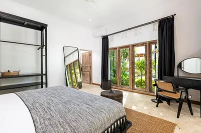 a bedroom with a bed and a piano at Villa Gauguin by Villa Finder in Seminyak