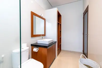 a bathroom with a sink and a mirror at Villa Kamboja Premium walk to double six Beach - enclosed living room with AC in Seminyak