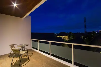 a balcony with a table and a chair on a balcony at M Suite Bali in Seminyak