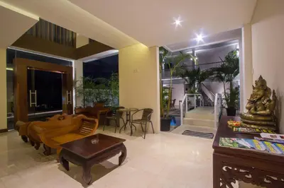 a living room with a couch and a table at M Suite Bali in Seminyak