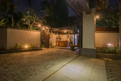 a patio of a house at night with lights at Bale Seminyak in Seminyak