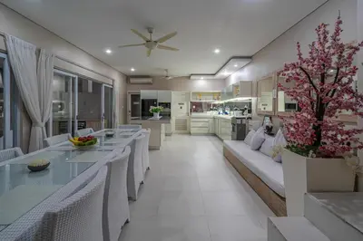 a dining room and living room with tables and chairs at VILLA BALI OM CENTER - Best Location, Beautiful Villa Near the Beach in Canggu