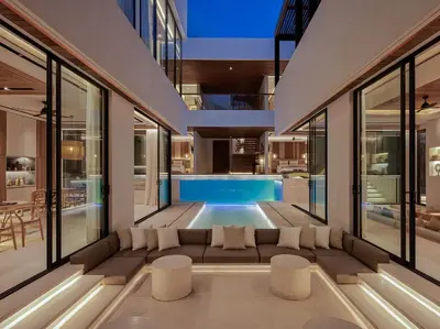 a living room with a couch and a swimming pool at Villa Nini Elly by Elite Havens in Canggu