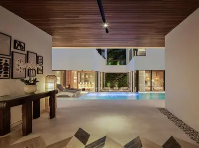 a living room with a swimming pool in a house at Villa Nini Elly by Elite Havens in Canggu