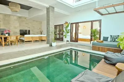 a living room with a swimming pool in a house at Villa Casey in Seminyak