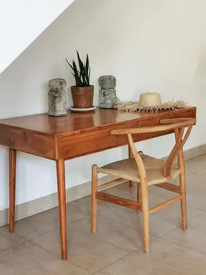 a wooden desk with a chair and a plant at Villa Casa Orana in Seminyak