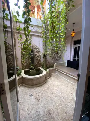 a garden with a fountain in the middle of a room at Blue Lagoon 5 bedrooms Villa in Kuta