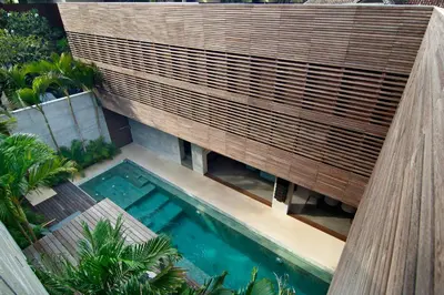 an overhead view of a swimming pool with a wooden fence at 4BR Villa Jumat - Minggu Villas Seminyak in Seminyak