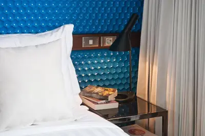 a bedroom with a bed and a table with a lamp at 4BR Villa Jumat - Minggu Villas Seminyak in Seminyak