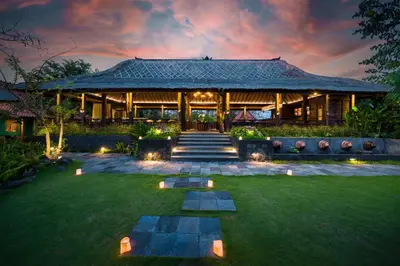 a house with a lawn in front of it at Villa Kapungkur in Jimbaran