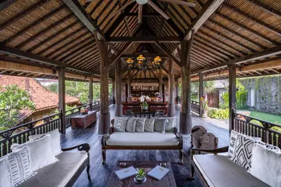 an outdoor pavilion with a couch and a table at Villa Kapungkur in Jimbaran