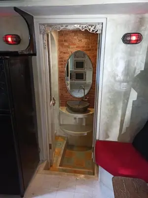 a bathroom with a sink and a mirror at Beach House Apartment in Legian