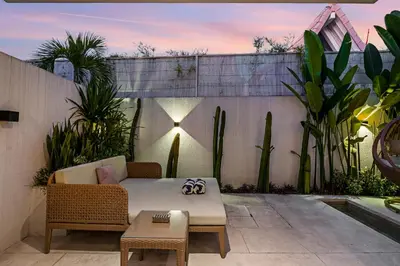 a patio with a couch and a table and some plants at Besso Villa by Betterplace in Canggu