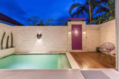 a swimming pool in a house with a purple door at Villa Floppy New 1 bedr villa private Pool 5min beach in Legian
