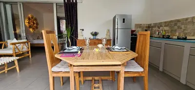 a wooden table and chairs in a kitchen at Villa Floppy New 1 bedr villa private Pool 5min beach in Legian