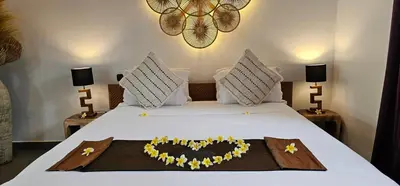 a bed with a heart made out of flowers on it at Villa Floppy New 1 bedr villa private Pool 5min beach in Legian
