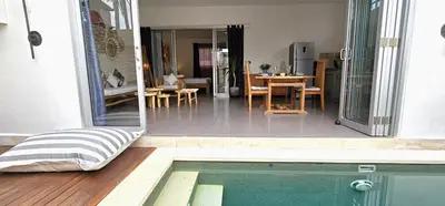 a house with a swimming pool and a dining room at Villa Floppy New 1 bedr villa private Pool 5min beach in Legian