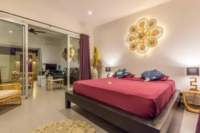 a bedroom with a large red bed and a living room at Villa Floppy New 1 bedr villa private Pool 5min beach in Legian