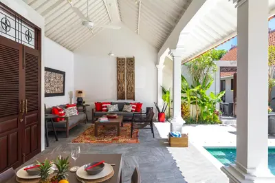 an outdoor living room with a couch and a table at Villa Rua - Stylish luxury, tranquil location in Legian, walk to beach in Seminyak