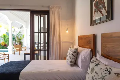 a bedroom with a bed and a sliding glass door at Villa Toru - Stylish luxury in Legian, tranquil location, walk to beach in Legian