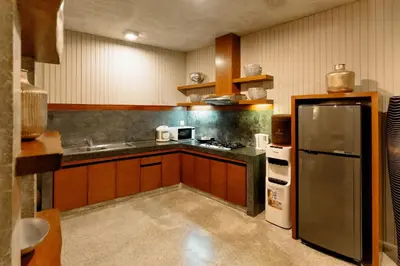 a kitchen with a stainless steel refrigerator and a sink at Bracha Villas Bali in Seminyak