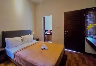 a bedroom with a bed with a towel on it at Andewi Homestay RedPartner - Minimum Stay 30 Nights in Pesanggaran