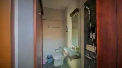 a small bathroom with a toilet and a sink at Andewi Homestay RedPartner - Minimum Stay 30 Nights in Pesanggaran