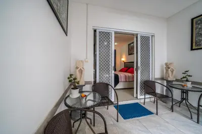 a living room with a table and chairs and a bedroom at Modern villa with private pool , full kitchen and parking in Legian