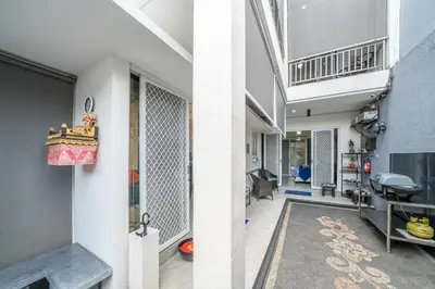 an internal hallway of a house with a living room at Modern villa with private pool , full kitchen and parking in Legian