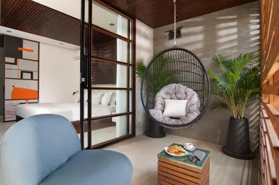 a room with a swing chair and a bedroom at 4BR Villa Kamis - Minggu Villas Seminyak in Seminyak