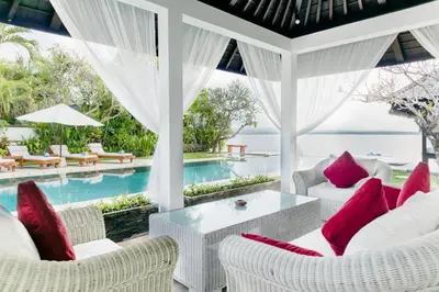 a room with a view of the pool and the ocean at Villa Sunset by Premier Hospitality Asia in Nusa Dua