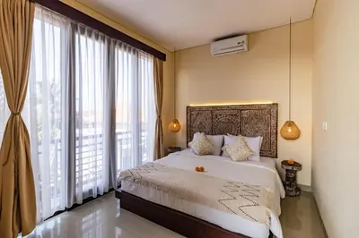 a bedroom with a large bed and a large window at NEWLY RENOVATED trendy 4bd Pvt villa in Seminyak in Seminyak