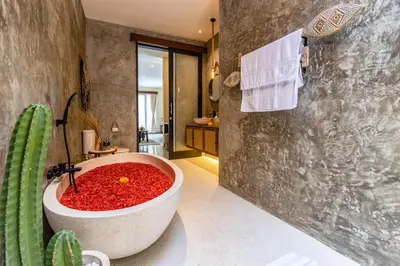 a bathroom with a large tub filled with red gravel at NEWLY RENOVATED trendy 4bd Pvt villa in Seminyak in Seminyak