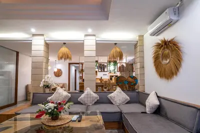 a living room with a couch and a table at Miracle villa Canggu in Canggu