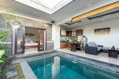 an indoor swimming pool in a house with a living room at Villa Estella ☆ Seminyak Kuta - Private Pool in Seminyak