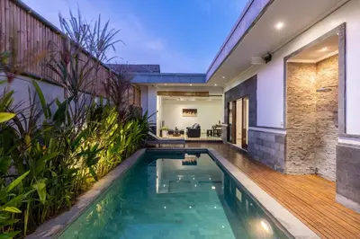 an infinity pool in a villa with a house at Villa Estella ☆ Seminyak Kuta - Private Pool in Seminyak
