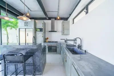 a kitchen with a concrete counter top and a sink at Villa Bali Townhouse 3 - Modern 2BR Villa with pool - PERFECT LOCATION in Canggu