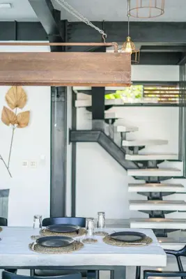 a table with plates on it next to a staircase at Villa Bali Townhouse 3 - Modern 2BR Villa with pool - PERFECT LOCATION in Canggu