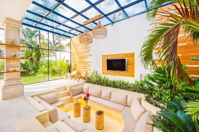 a living room with a white couch in a room with plants at Villa Dublin - Luxury 5 BDR w Jacuzzi & Pool in Seminyak