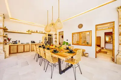 a dining room with a long table and chairs at Villa Dublin - Luxury 5 BDR w Jacuzzi & Pool in Seminyak