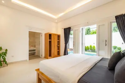 a bedroom with a large bed and a large window at Amazing Villa in Oberoi Top Location in Seminyak