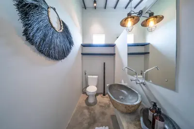 a bathroom with a sink and a mirror at Villa Wiraja 1 - Modern 4 bdr villa in Berawa in Canggu