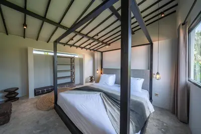 a bedroom with a large bed in a room at Villa Wiraja 1 - Modern 4 bdr villa in Berawa in Canggu