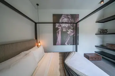 a room with a bed and a picture on the wall at Villa Wiraja 2 - Classy 4 bdr villa in the heart for Canggu in Canggu