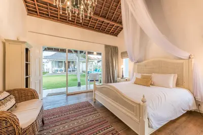 a bedroom with a bed and a window at Sol Lila Bali in Canggu